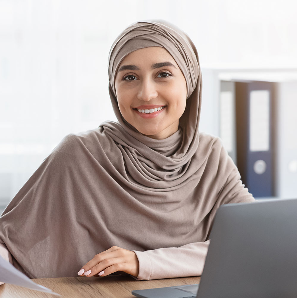 happy muslim businesswoman in hijab with papers at p8zccjx 1.jpg