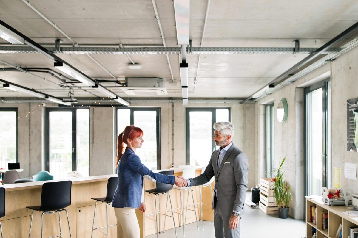 two business people in the office shaking hands pwrs4yc.jpg